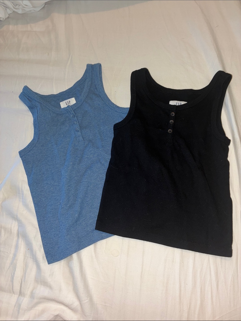 Two Gap Teen ribbed, cropped tank tops with three buttons. Black is M, Blue is L